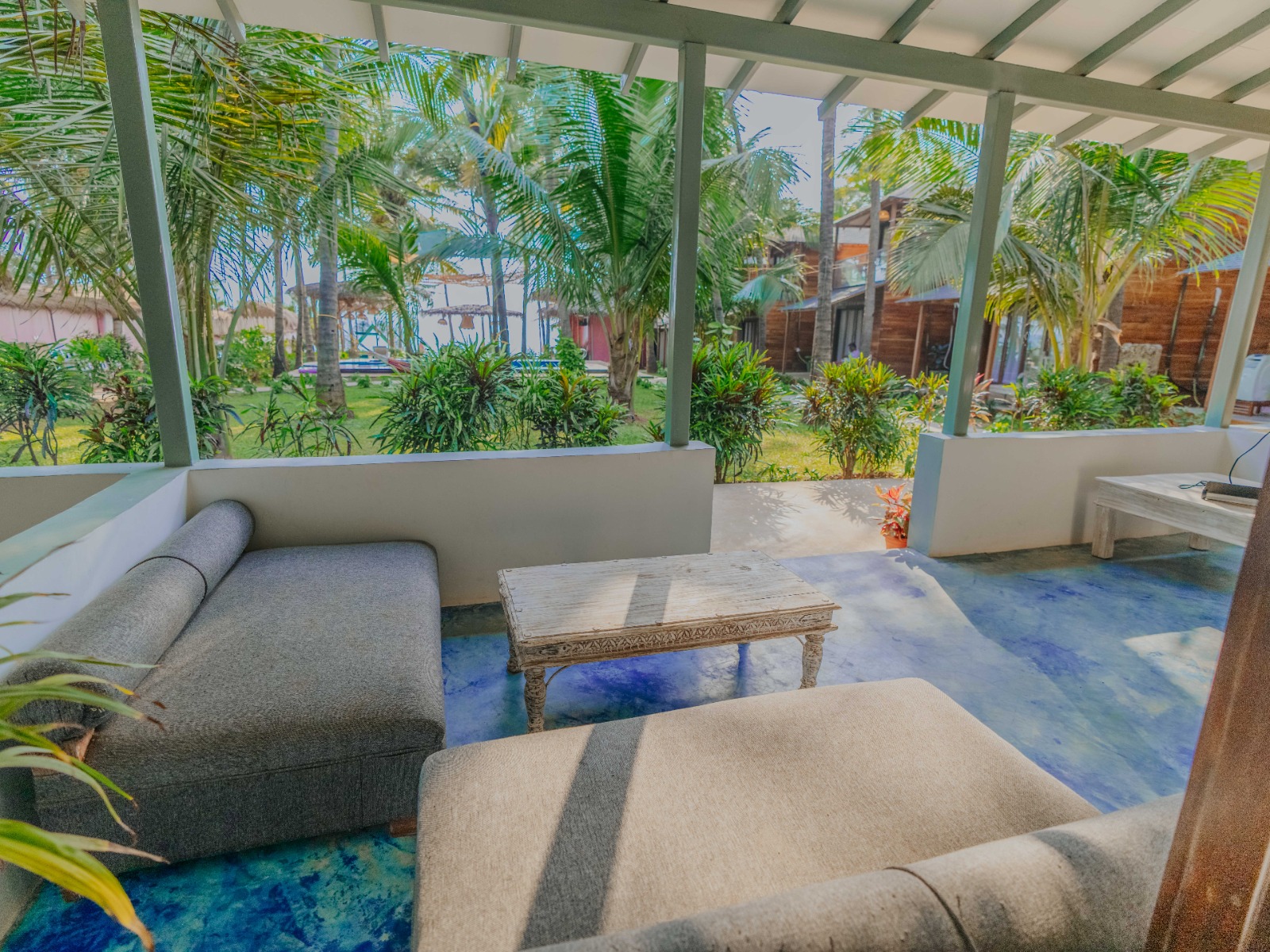 Open lounge overlooking palms and pool