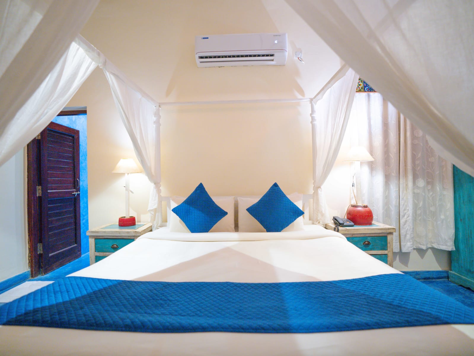 Canopy bed in an AC cottage room
