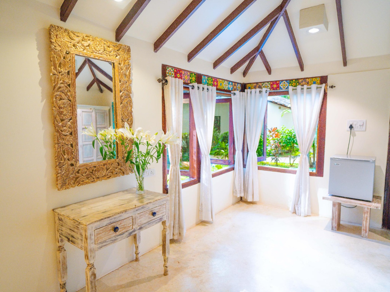 Cottage interior with carved mirror and flowers