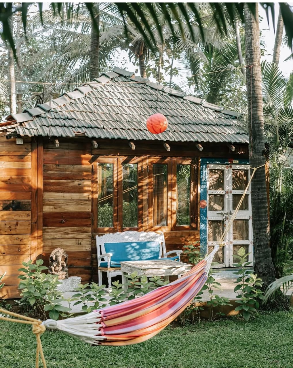 Leela Cottages Resort cottage with hammock among palm trees